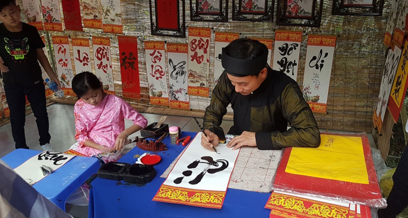 You may see some calligraphers at Tay Phuong pagoda